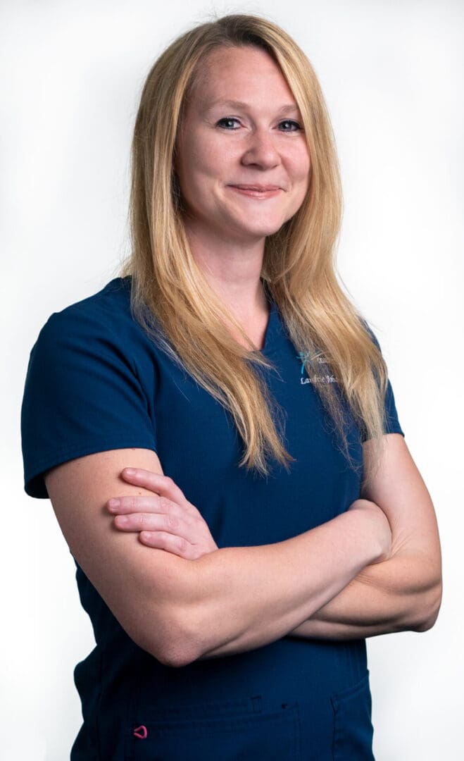 A woman with her arms crossed in front of the camera.