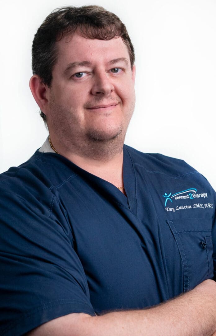 A man in blue shirt and white shirt standing.